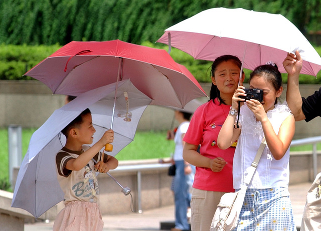 Shanghaibor skyddar sig mot solen. (Arkivbild)