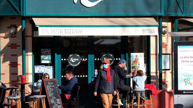 En mann med munnbind utenfor en restaurant i Saint Jean de Luz, sørvest i Frankrike. Foto: Bob Edme / AP / NTB