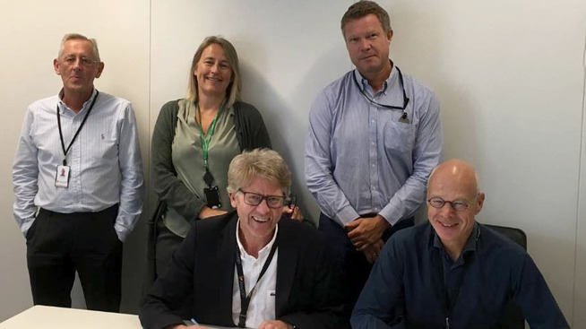 Prosjektdirektør Olav Henriksen (nede til venstre) i Aker BP signerer avtalen om en modifikasjonsallianse med Aker Solutions
